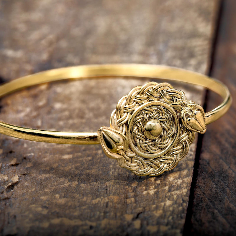 ‘Close-up of bangle in recycled silver, gold plated, snake design, the Wise One collection.’
