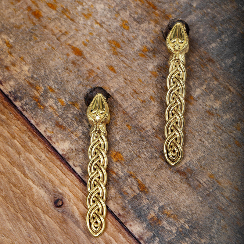 ‘Close-up of earrings, recycled silver, gold plated, serpent design, the Wise One collection.’