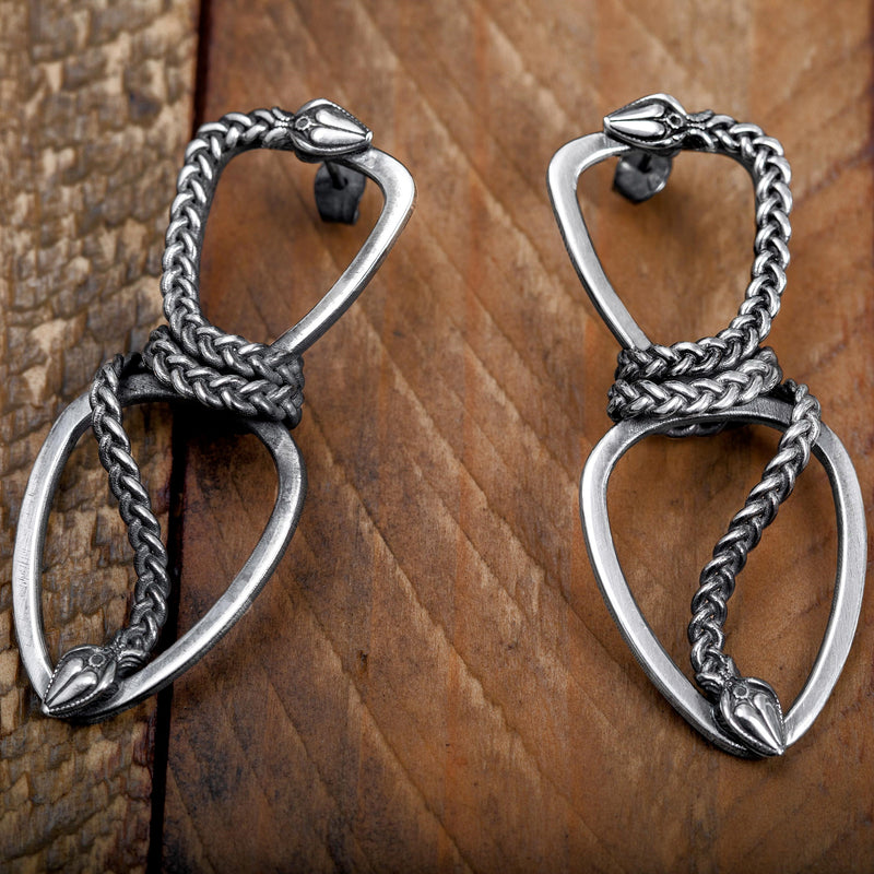 ‘Close-up of Infinity earrings in recycled silver, snake design, the Wise One collection.’