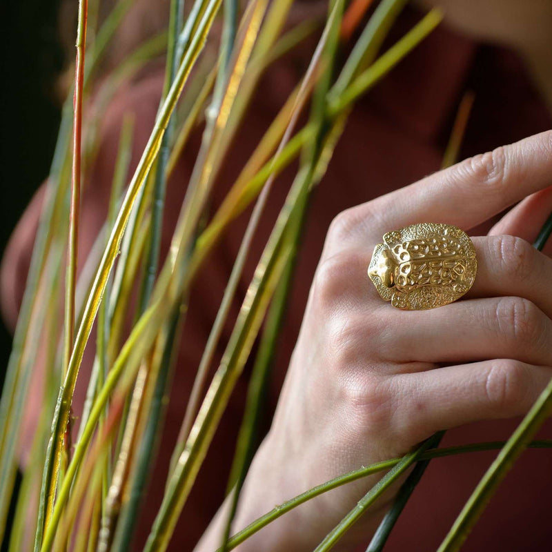 'Statement ring made of recycled silver, gold plated, the messenger collection, beetle design,  Ferunas sustainable jewellery.'