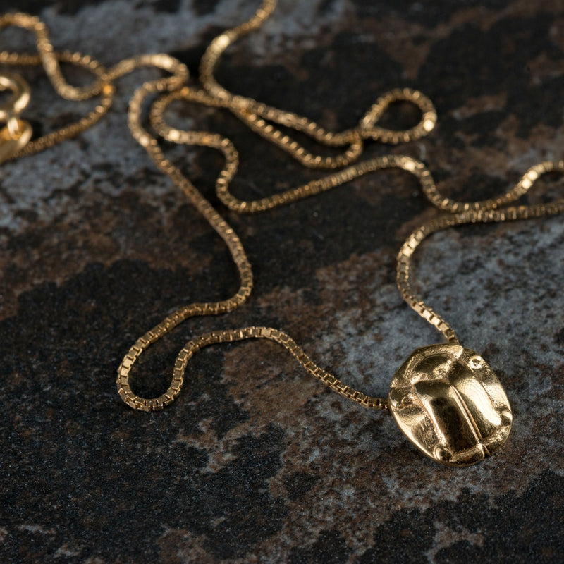 ‘Small beetle pendant in recycled gold, the messenger collection.’
