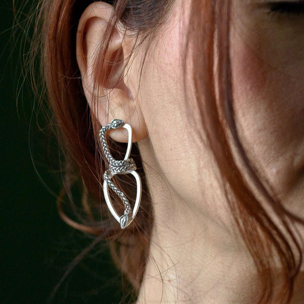 ‘Close-up of Infinity earrings in recycled silver, serpent design, the Wise One collection.’