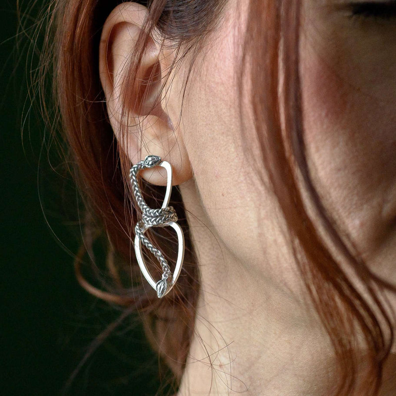 ‘Close-up of Infinity earrings in recycled silver, serpent design, the Wise One collection.’