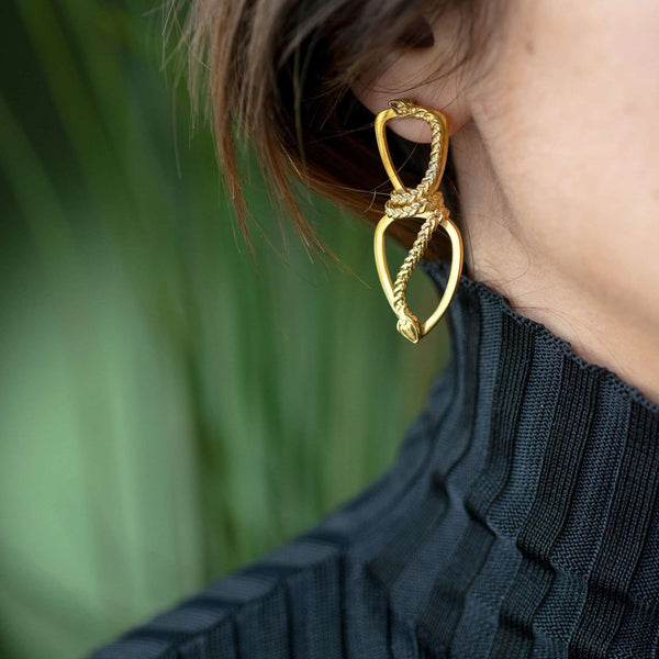 ‘Close-up of Infinity earrings in recycled gold, serpent design, the Wise One collection.’