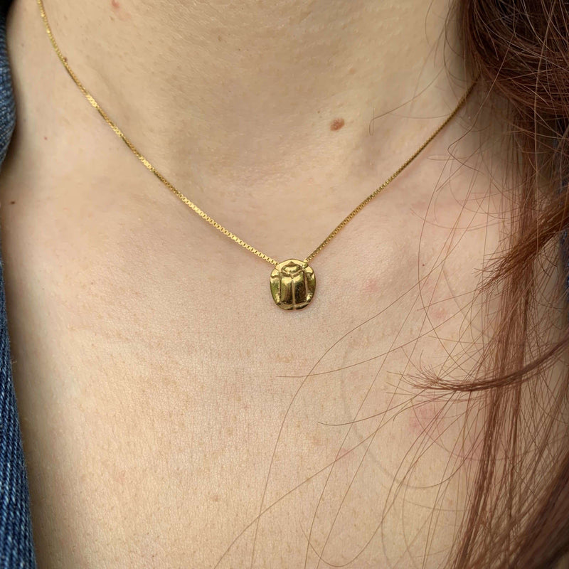 ‘Close-up of small beetle pendant in Fairtrade gold, the messenger collection.’